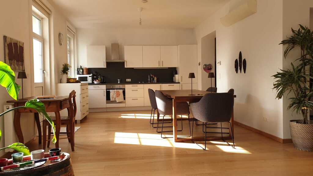 Dining area with open-plan kitchen, view from living area