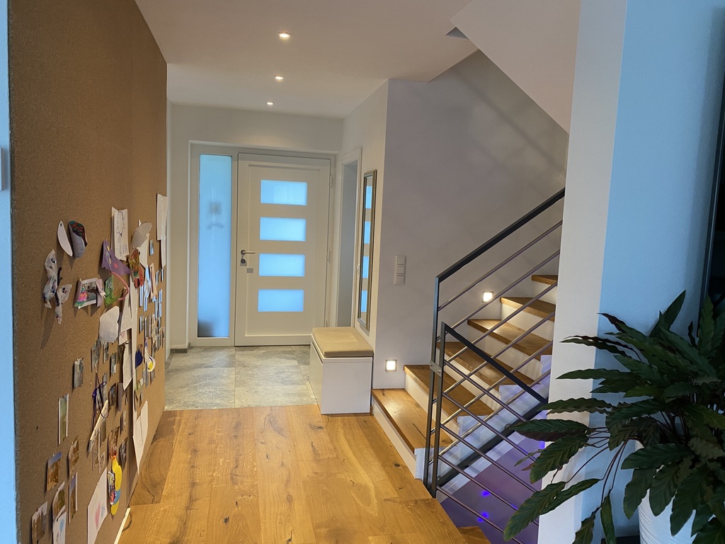 Corridor with staircase and entrance door