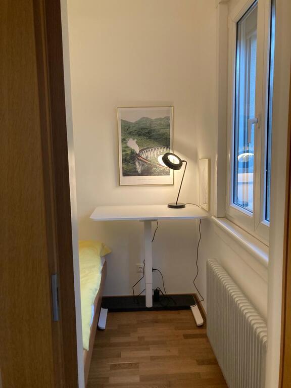 Bedroom with desk adjustable in height