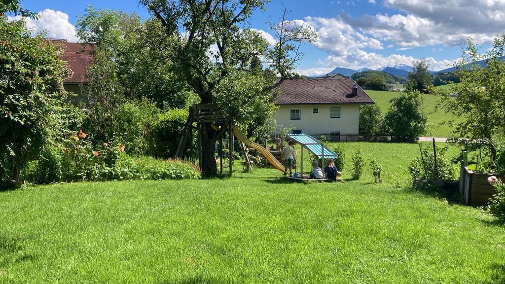 the garden with slide, sandpit and swing