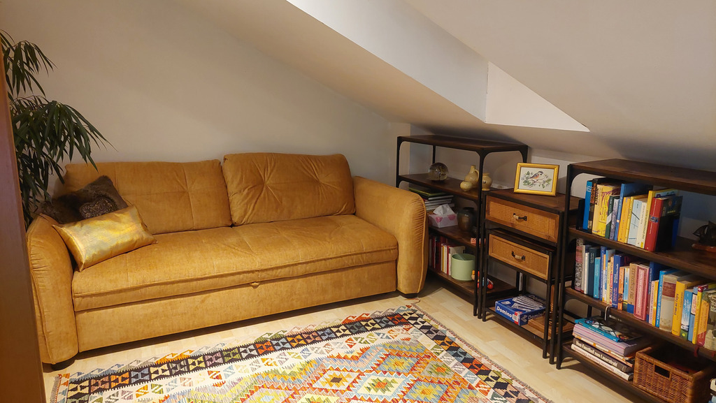 Wohn-Fernseh-Mansardenzimmer mit großer Schlafcouch