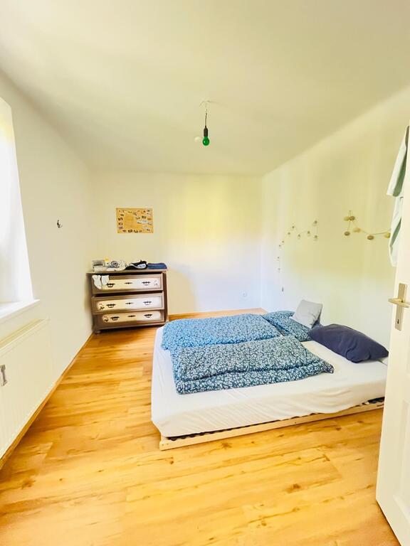 12,4m2 SleepingRoom with Window - FreshAir and really quiet and peaceful at night with a low-frame double bed and a green vie...