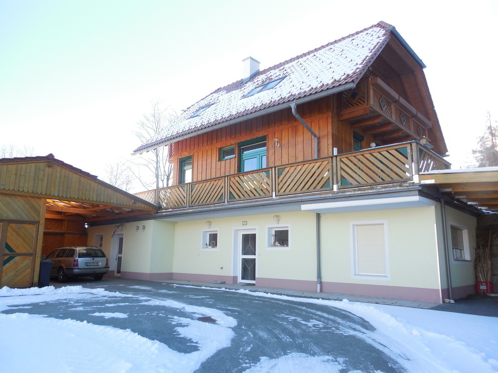 KRAKAUSCHATTEN_ front view of the house with covered parking space, and big terrace