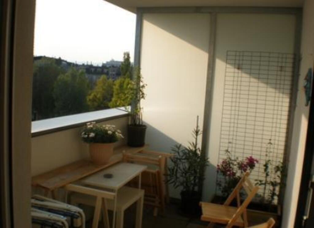 Living room with kitchen and balcony