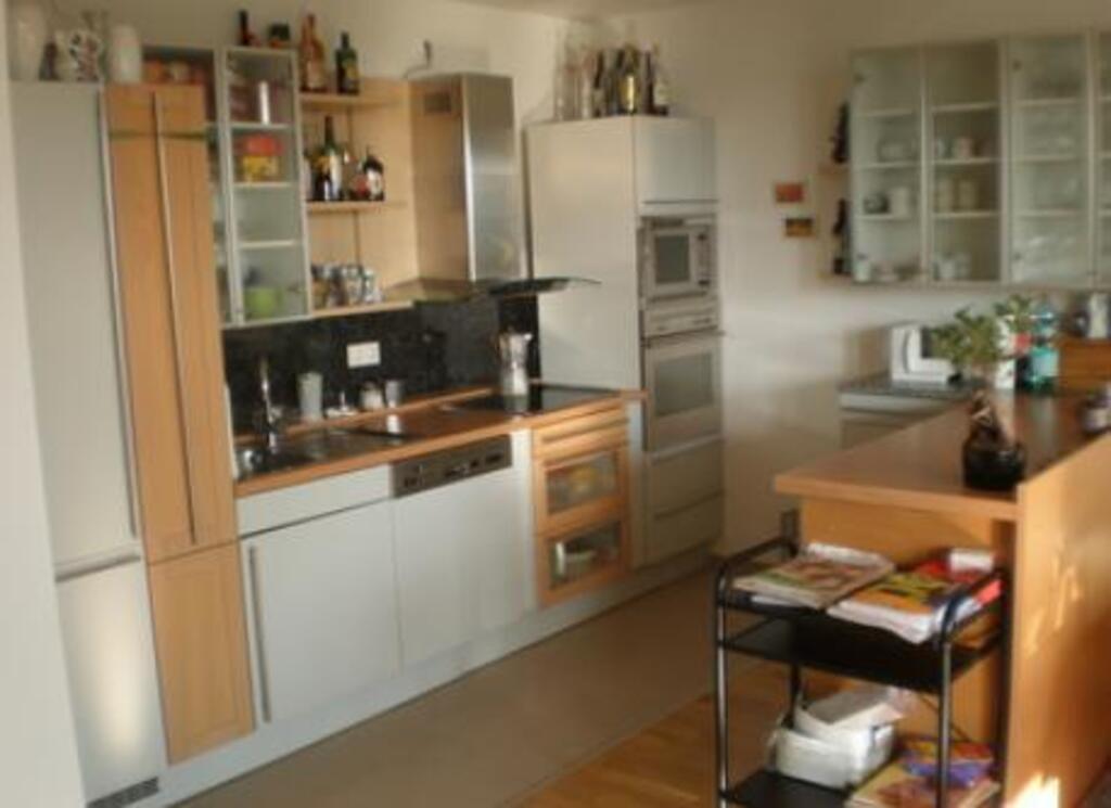 Living room with kitchen and balcony