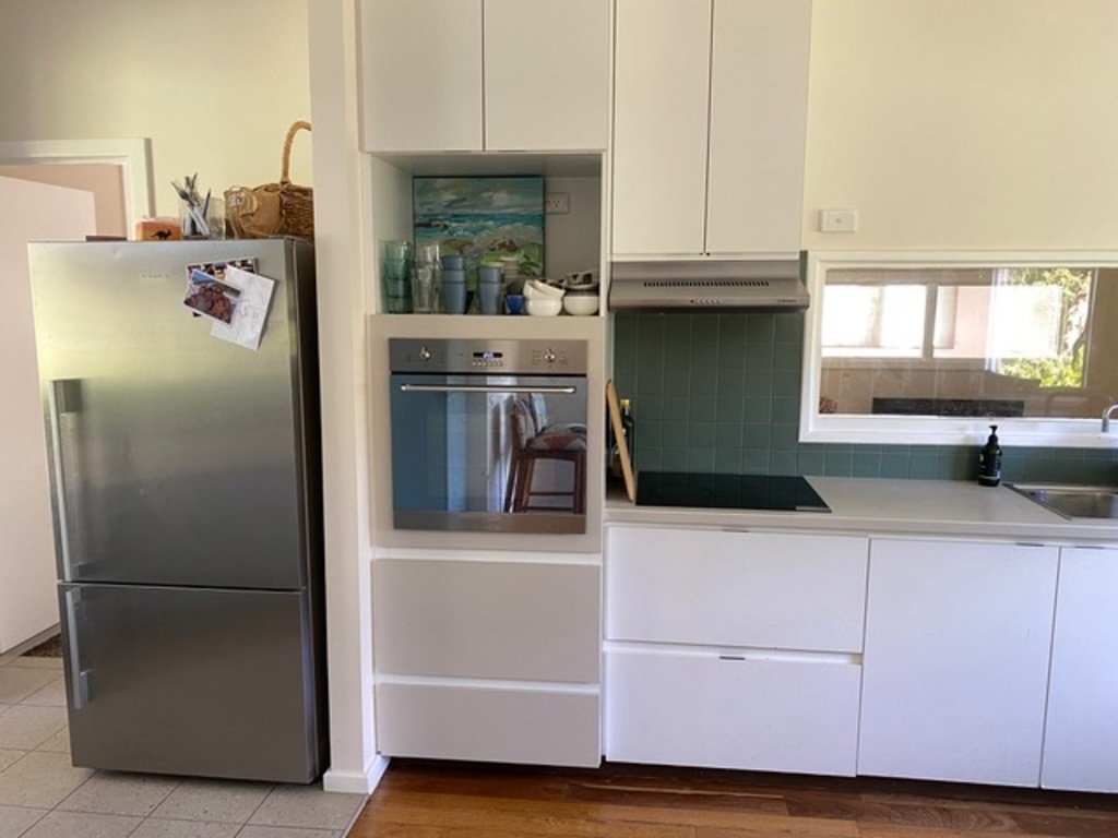 kitchen showing fridge, oven and cook top