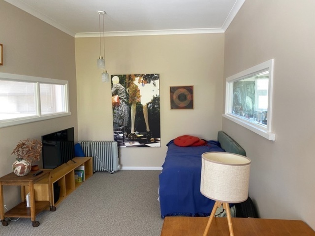 Spare lounge with TV and bed adjoins second bedroom. Has double french doors onto back garden.