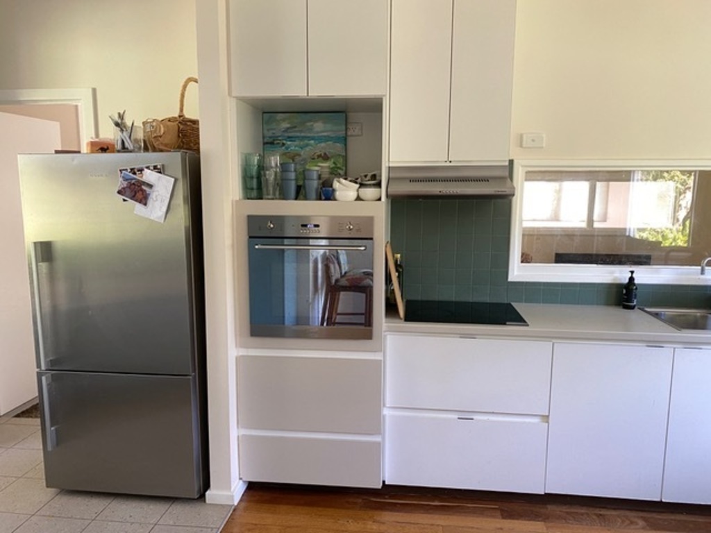 kitchen showing fridge, oven and cook top