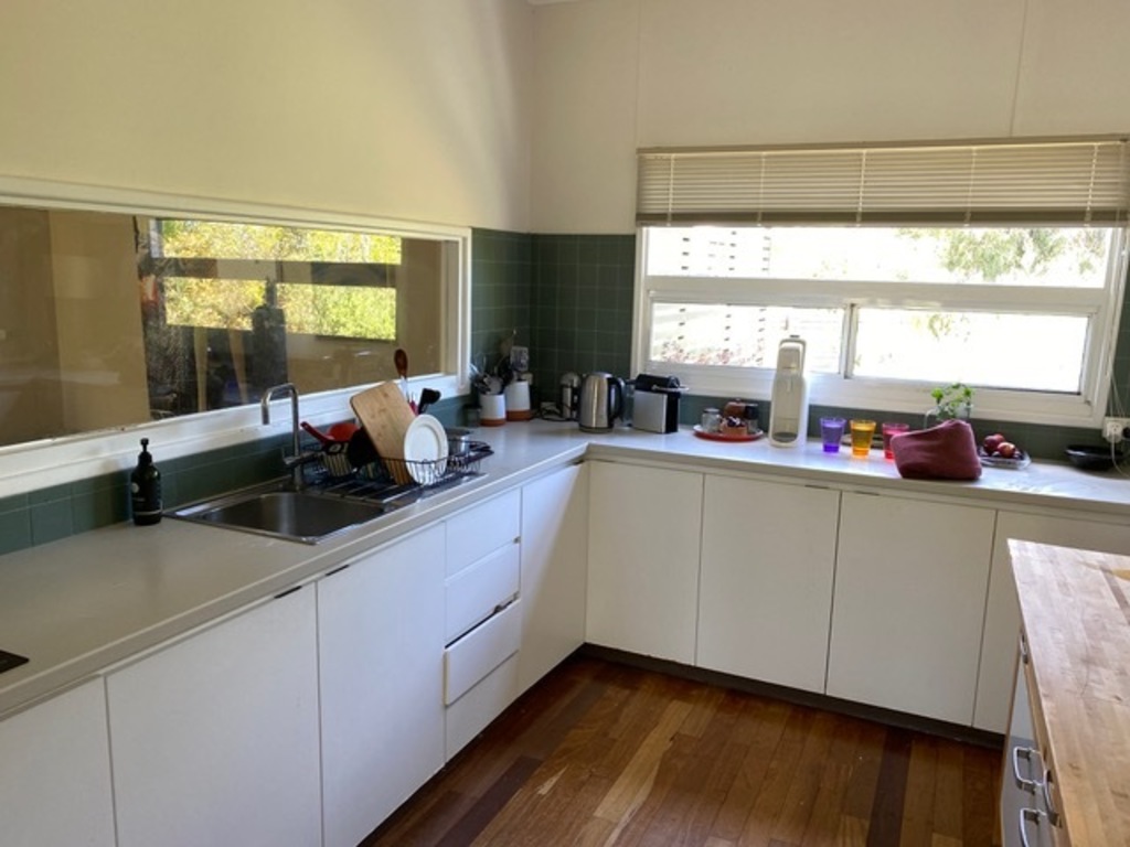 kitchen showing sink and cupboards space, window to front garden, private