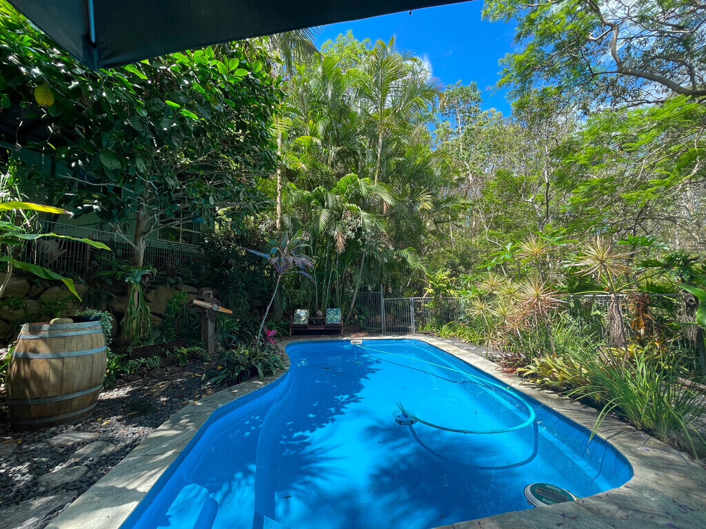 Pool area from the table and chairs, under the shade umbrella