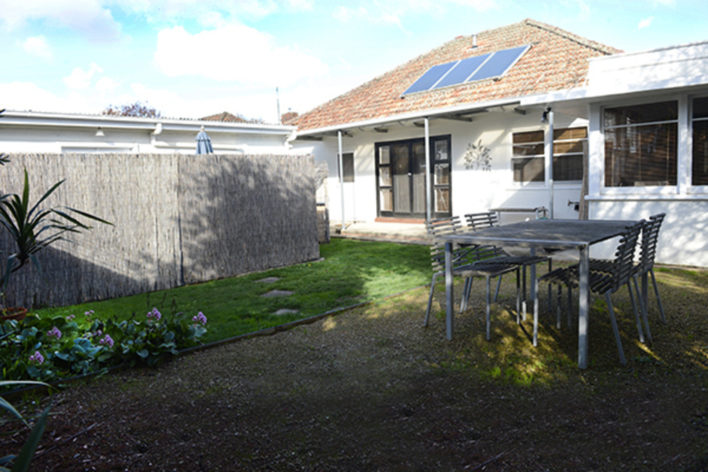 Back garden for dining with table, chairs and umbrella