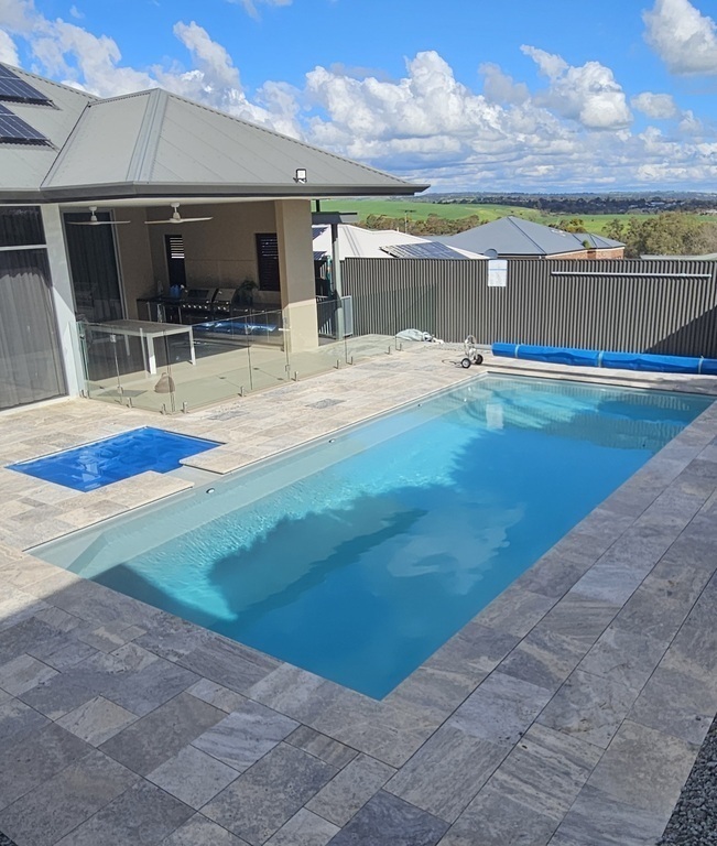 Pool, with outdoor kitchen in the background 