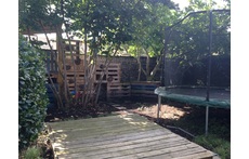Children's play area with tree house, big sandpit and trampoline