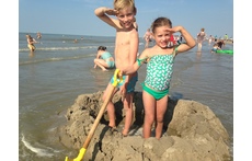 Timon and Jutta at the North sea building a castle in the sand