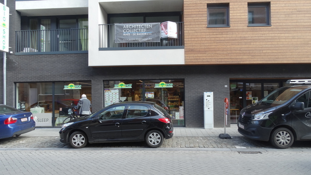 front of the building with big bamboowall. The ground floor is our organic shop (about 450m²). The balcony on the left is ours.
