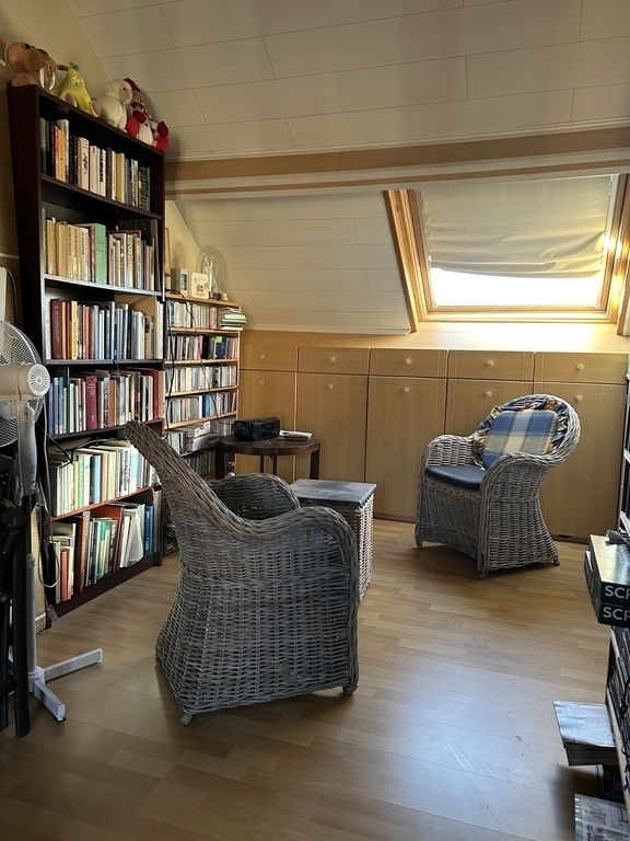 Guest-room; Sitting corner with Bookcases ( books and CD's ) An old fashioned Portable CD player is present.