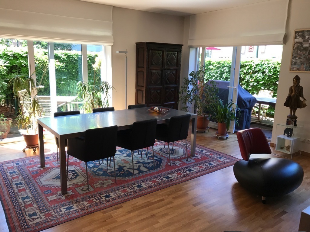Living room with aircon, dining table and view of the terrace (faces south and west)