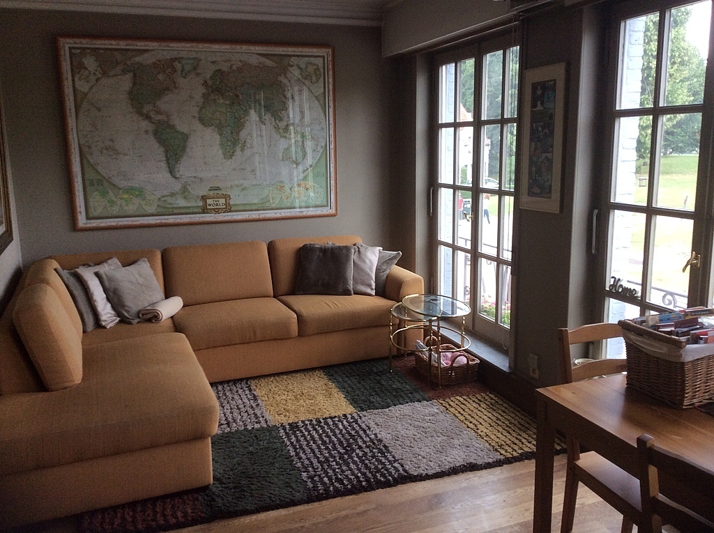 Living room, couch corner with view of windmill and grass zone around it in front of our home