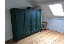 Spacious, bright attic with desk and sofa on the third floor.