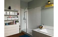 Large bathroom with bath, shower, toilet and two sinks on the first floor.