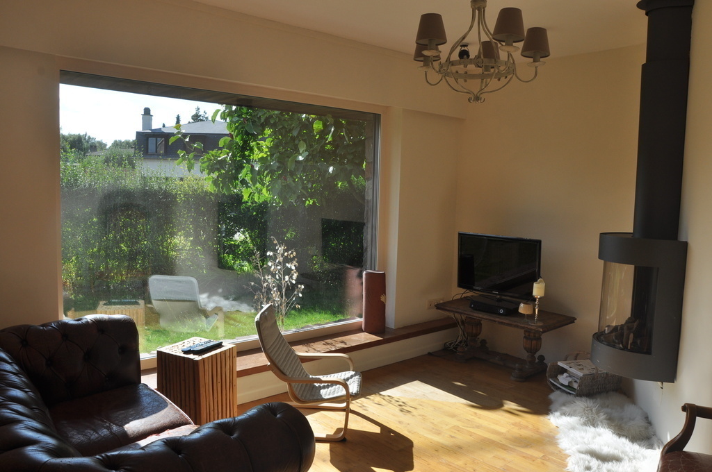 Sitting room with gas fireplace and a view of the front garden