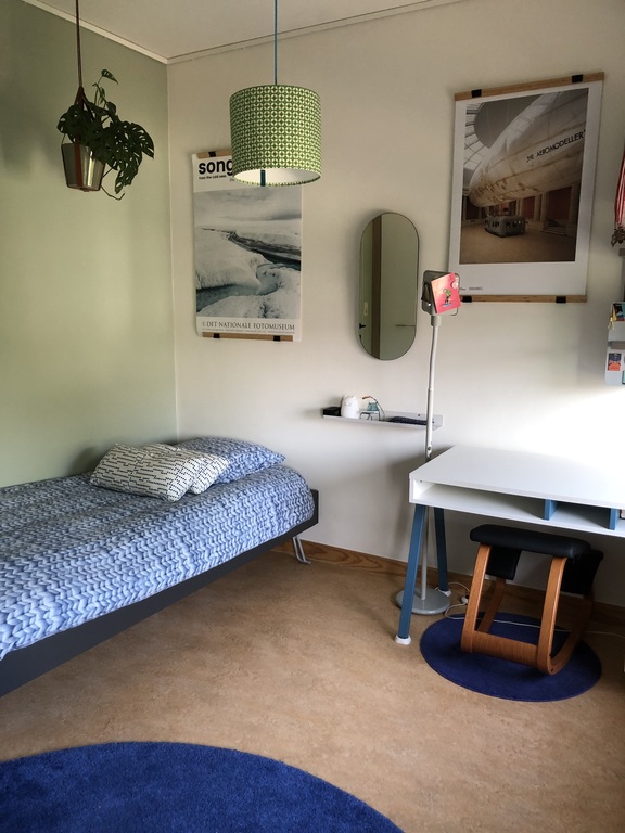 Single bed and desk in the separate bedroom.