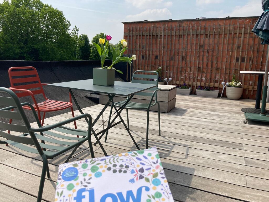 Large suncovered rooftop terrace overlooking the green environment.