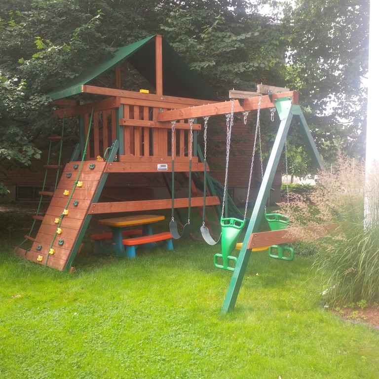 Backyard hideout, with climbing wall, slide and swings
