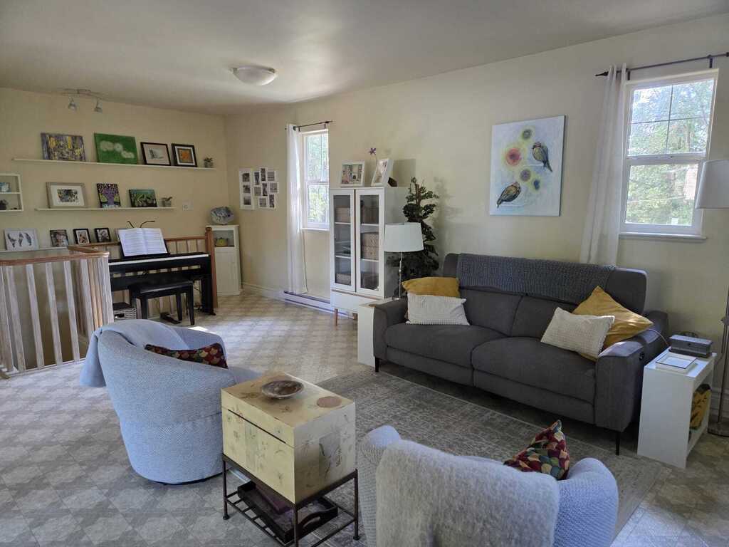 Piano alcove off the living room, stairs lead to downstairs to the primary bedroom, and small bedroom.