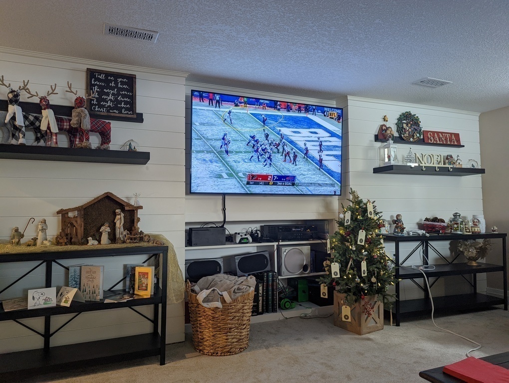 Lower floor living room with large TV and gaming system