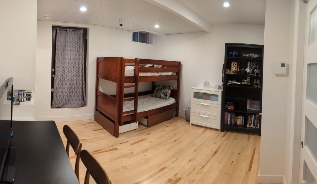 Bedroom 2: Kids bedroom with bunk bed. Has a standing desk and TV.