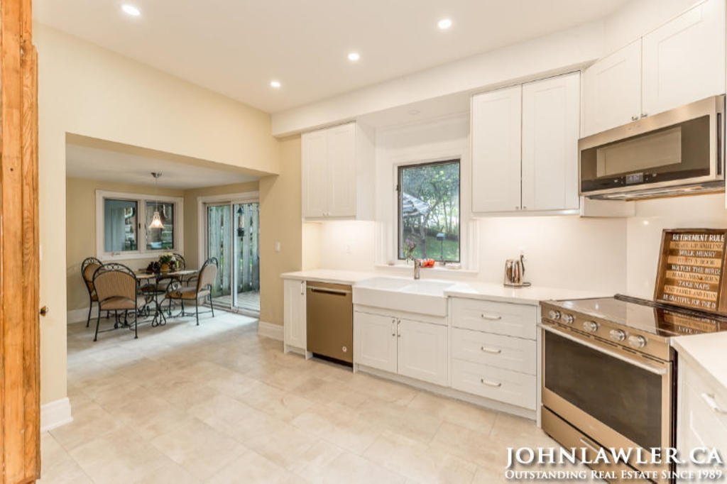 Kitchen has a seating area and sliding door to the backyard deck