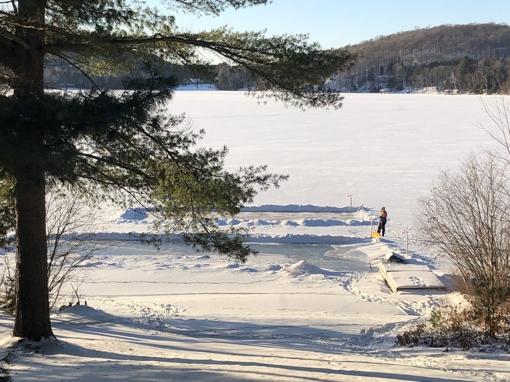 Shovelling curling and skating rinks on the lake