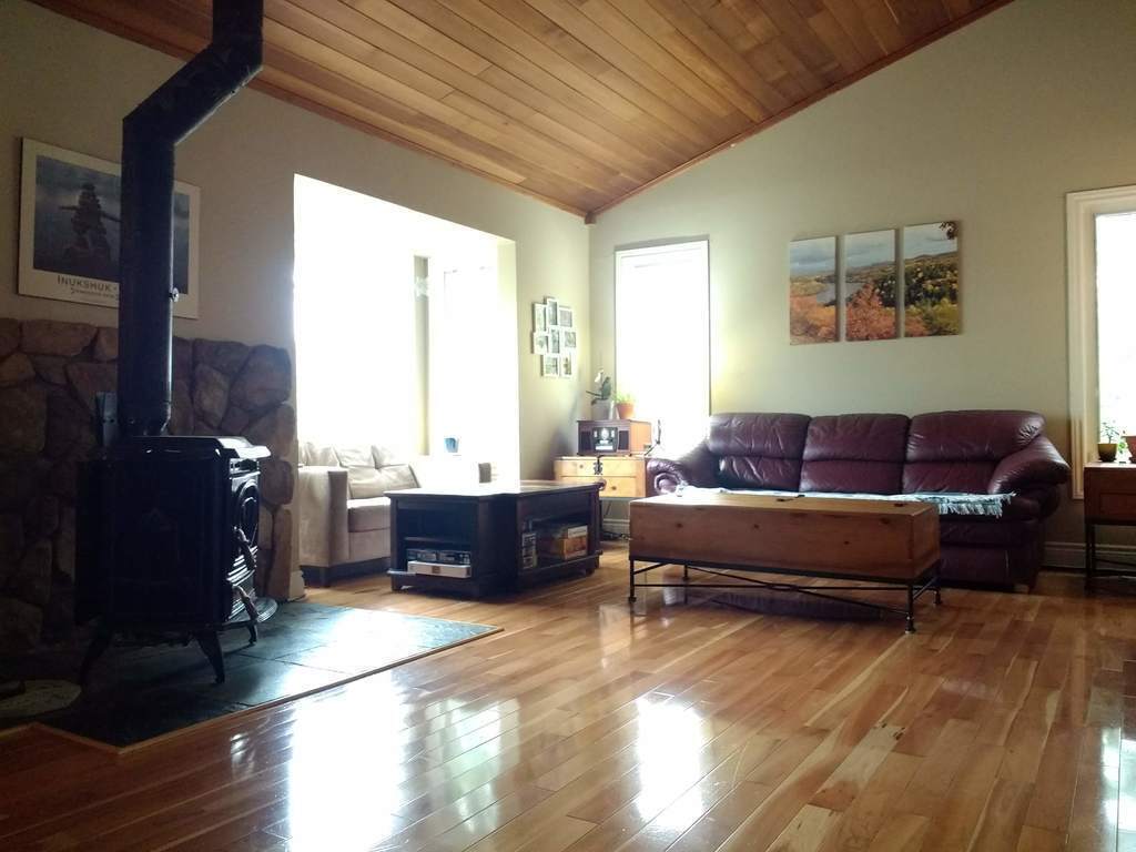 Living room with fireplace and cathedral ceiling