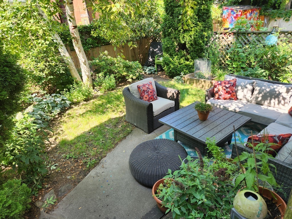 Landscaped backyard with raised bed - growing veg and herbs