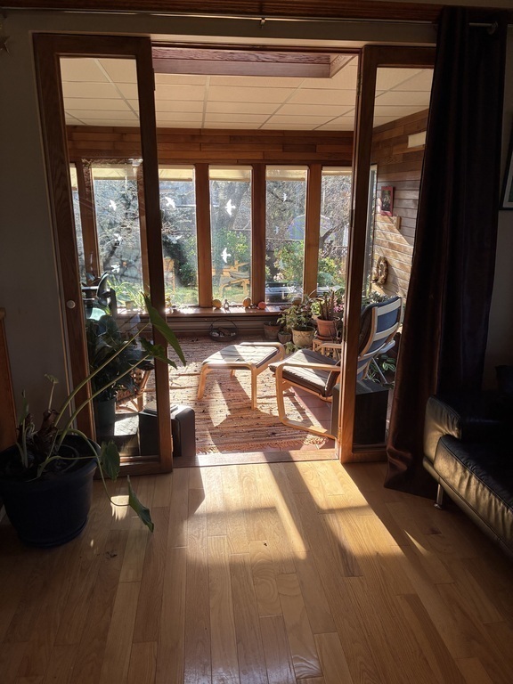 Sun Room which overlooking the backyard with all its trees, shrubs and flowers.