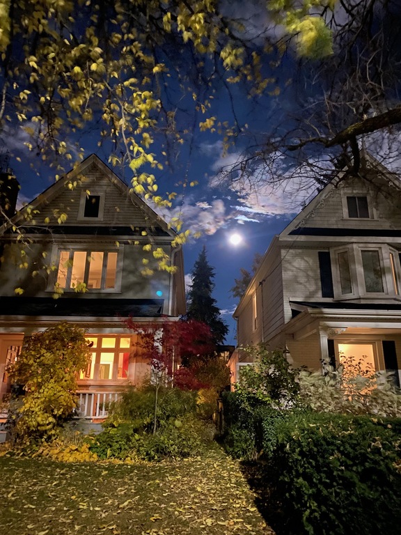 Our house on the left during a full moon! Front porch perfect for watching the world go by and chatting with neighbours.
