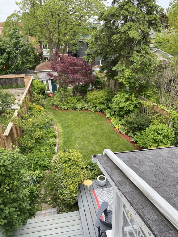 Our green backyard has a porch for morning coffee and a dining table and BBQ for evening meals under the lilac trees. There i...