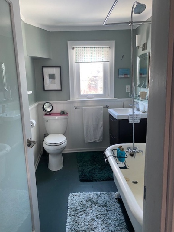 Bathroom with deep claw foot bathtub and shower.