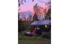 The front porch overlooks the pond.  There are four Muskoka chairs perfect for morning coffee or night-time star gazing.  