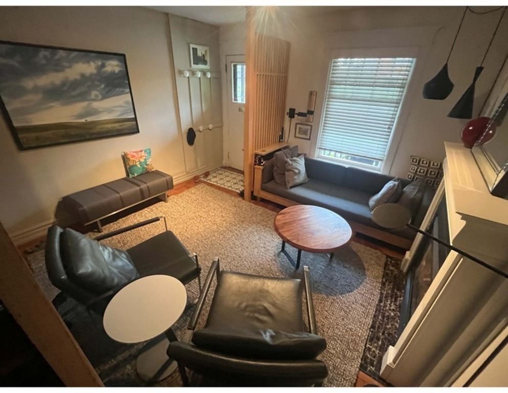 Living room with open screen at the front door