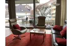 Living room with balcony facing quiet garden
