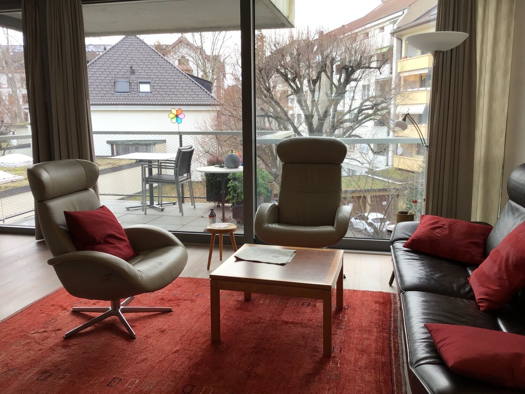 Living room with balcony facing quiet garden