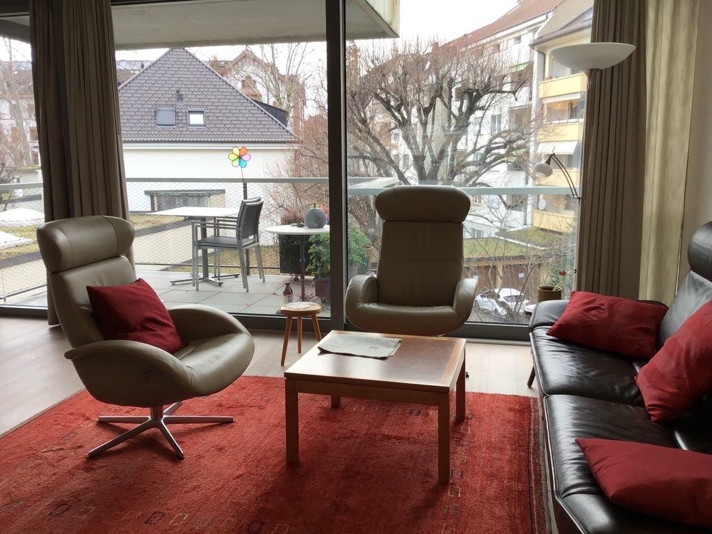 Living room with balcony facing quiet garden