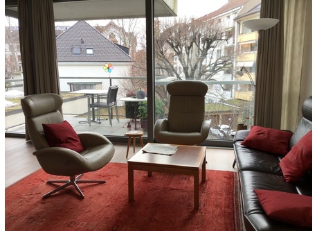 Living room with balcony facing quiet garden