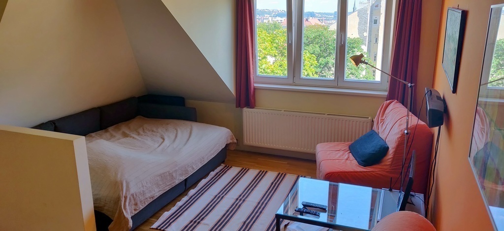 main living area with made-up double bed