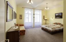 Bedroom with king-size double bed and foldable sofa.