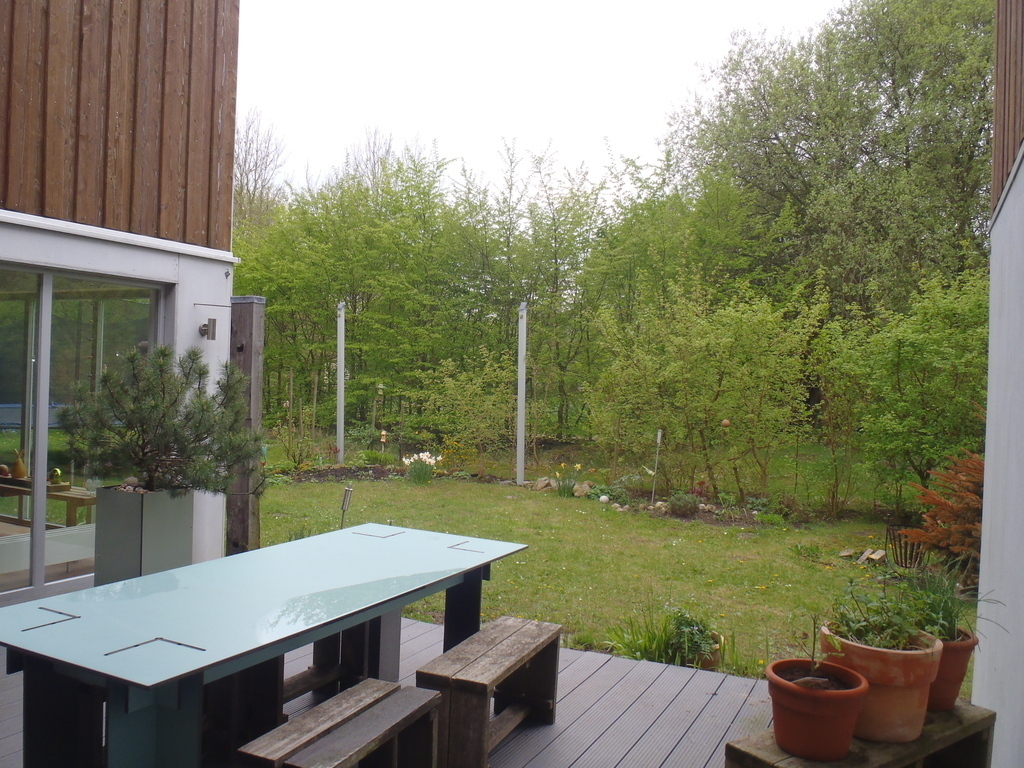 The patio is tucked away behind the house with a view into the forest.
