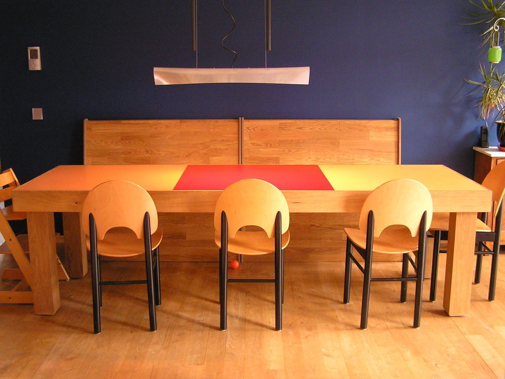 The dining room table, with a bench on one side