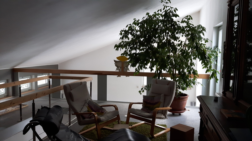 A balcony above the living room provides an extra indoor sitting area.